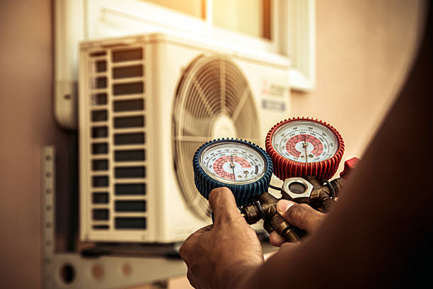 Professional Air Conditioning Service technician working in Nixa, MO